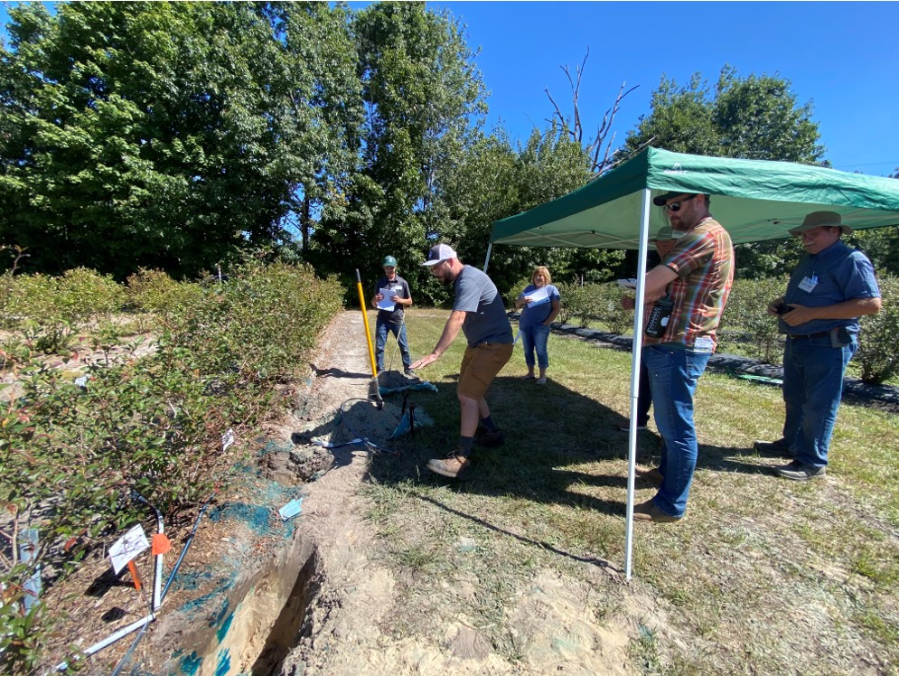 Irrigation crop report people under tent .jpg